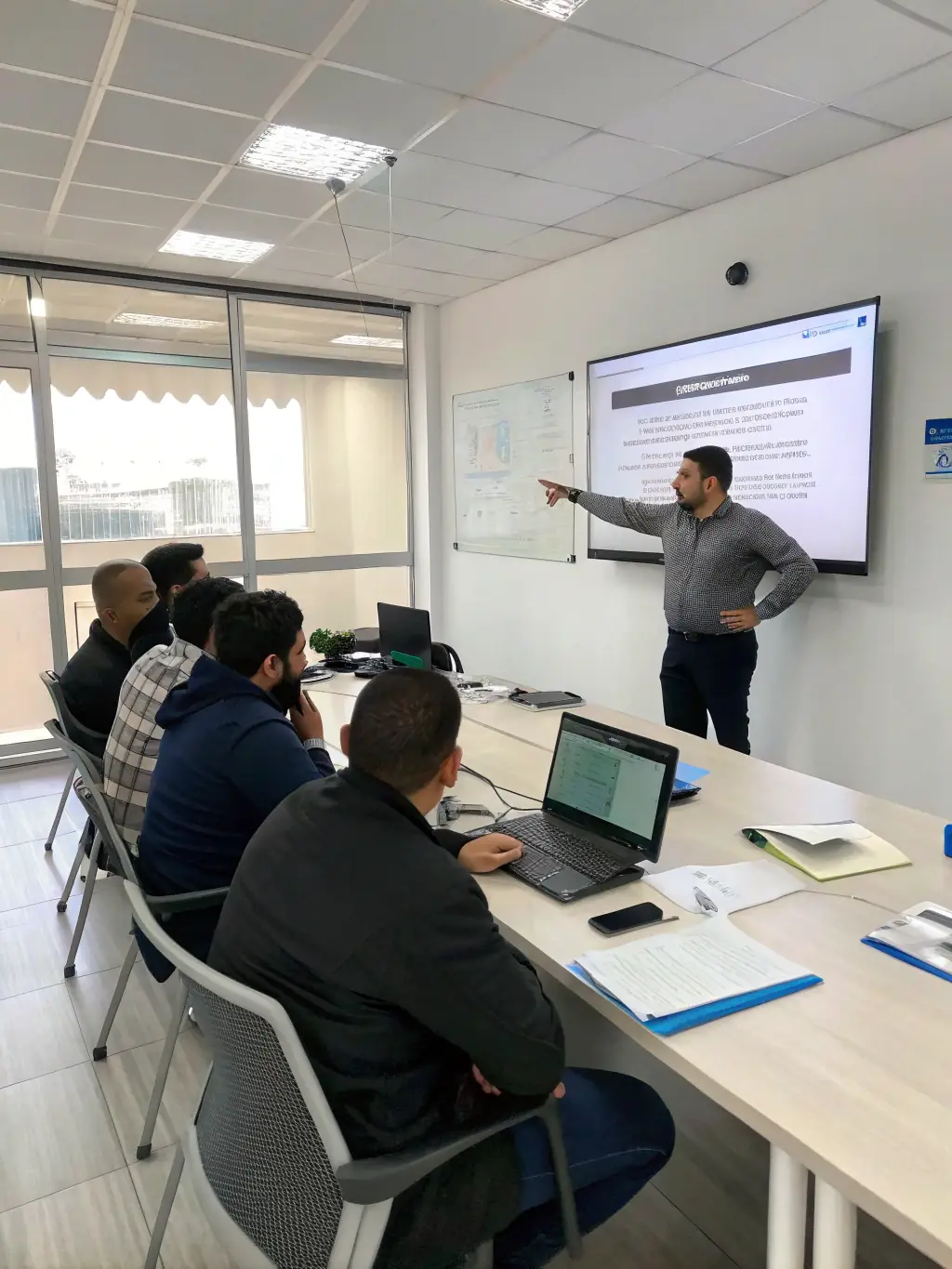 A consultant conducting a cyber security training session with employees.